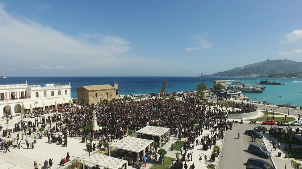 Thousands gathered at Zakynthos Town square for the Easter procession, harbour in the background
