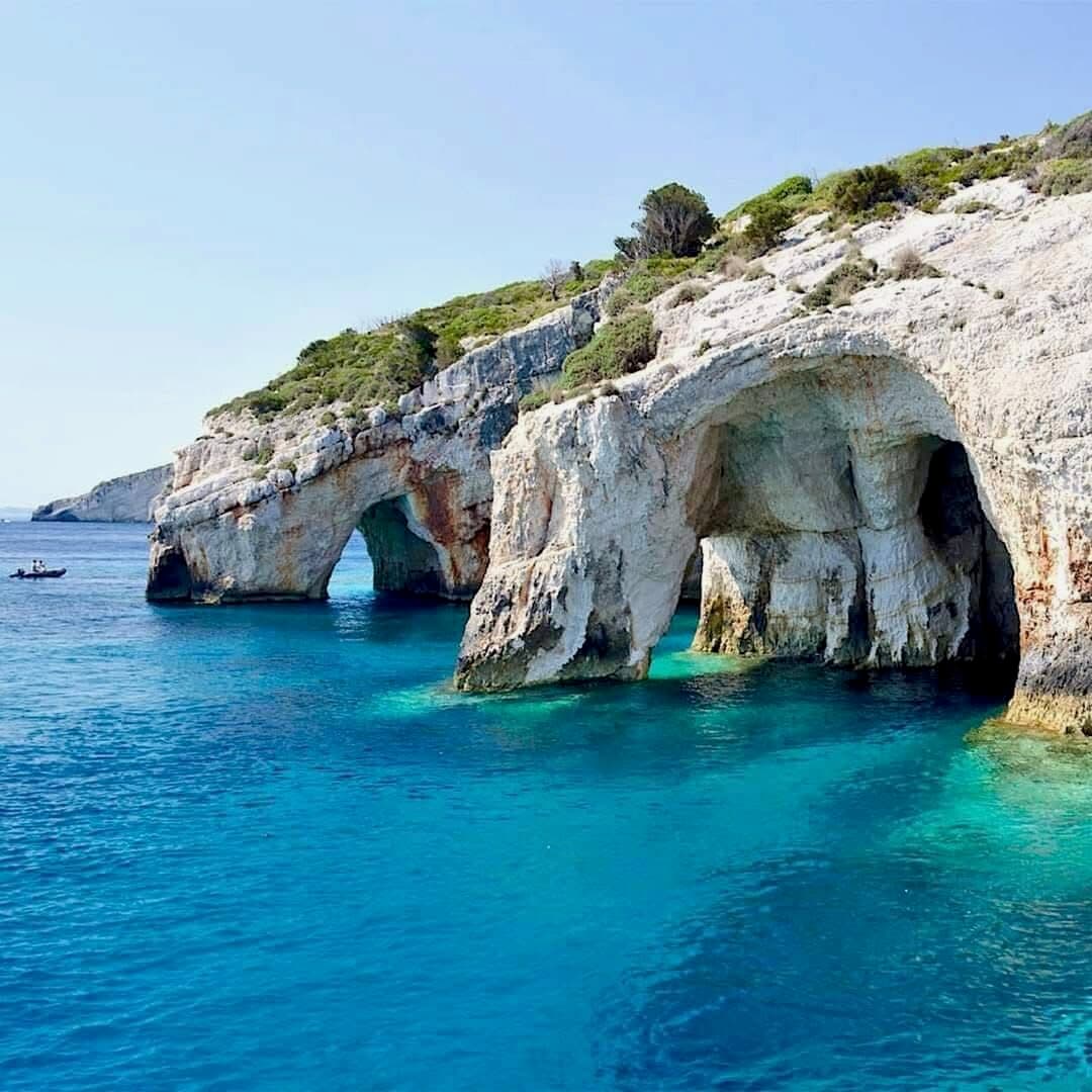 Multiple Blue Caves arches seen from the sea with turquoise water
