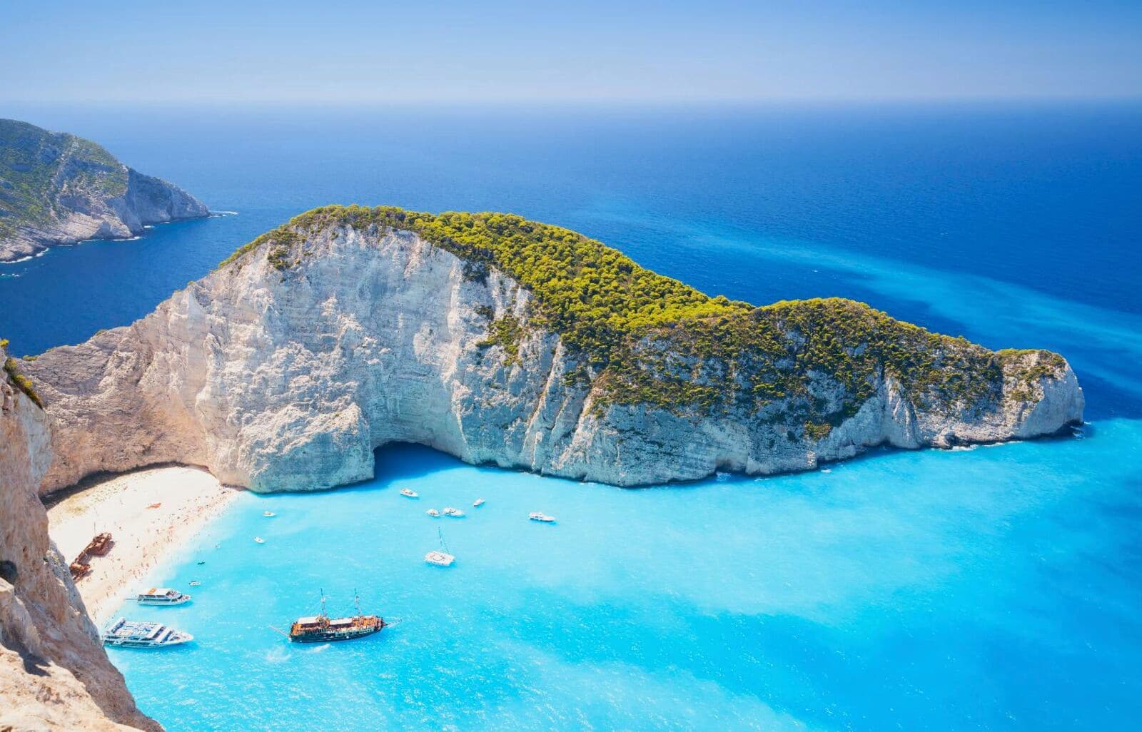 Navagio Beach headland and turquoise bay from above