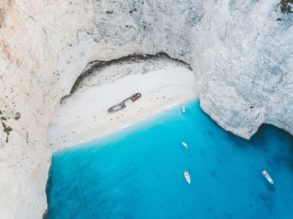 Aerial view of Navagio Shipwreck Beach with turquoise water and white cliffs